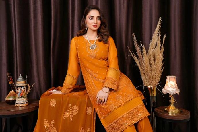 a woman sitting on a table in a yellow dress